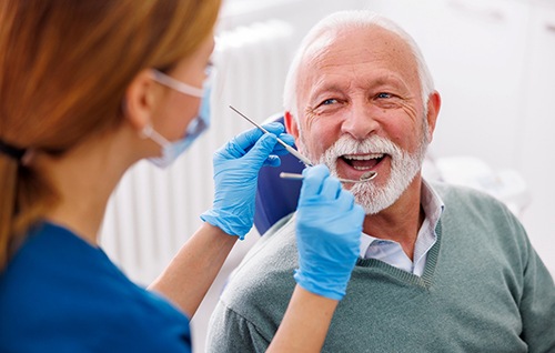Man smiles at dentist?