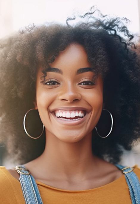 Closeup of woman with white teeth smiling outside