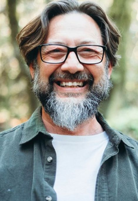 a man smiling after getting dental crowns