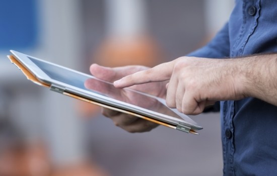 Man typing on tablet