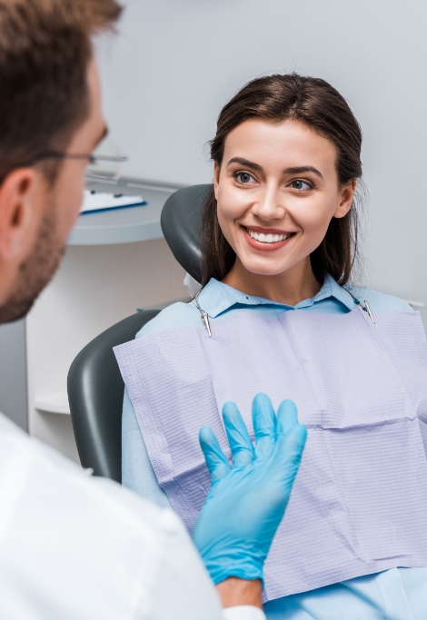 Young woman smiling while talking to her Shelburne dentist
