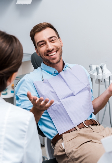 Smiling man talking to his dentist in Shelburne