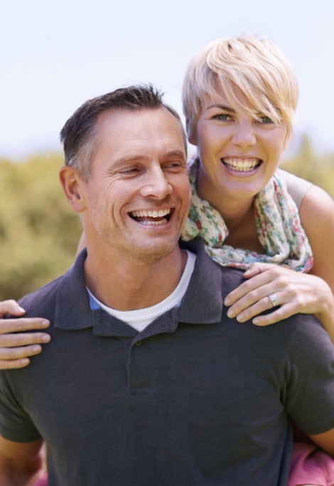 Smiling man and woman after restorative dentistry in Shelburne