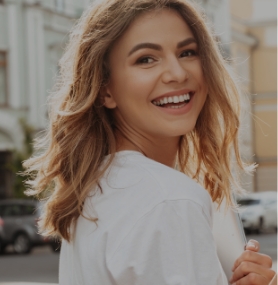 Blonde woman smiling outdoors