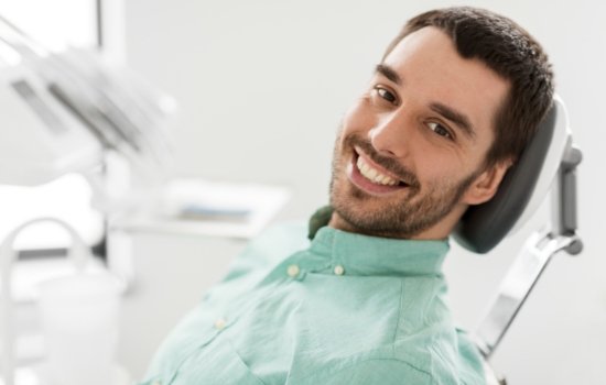 Young man smiling in dental chair