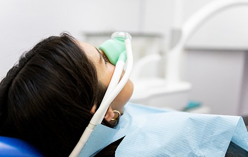 Patient breathing in nitrous oxide in treatment chair