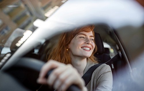 Woman smiling while driving