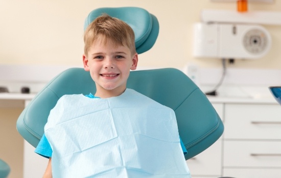 Young boy smiling in dental chair