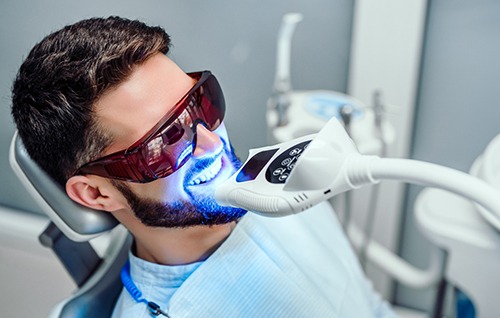 Male patient receiving in-office teeth whitening