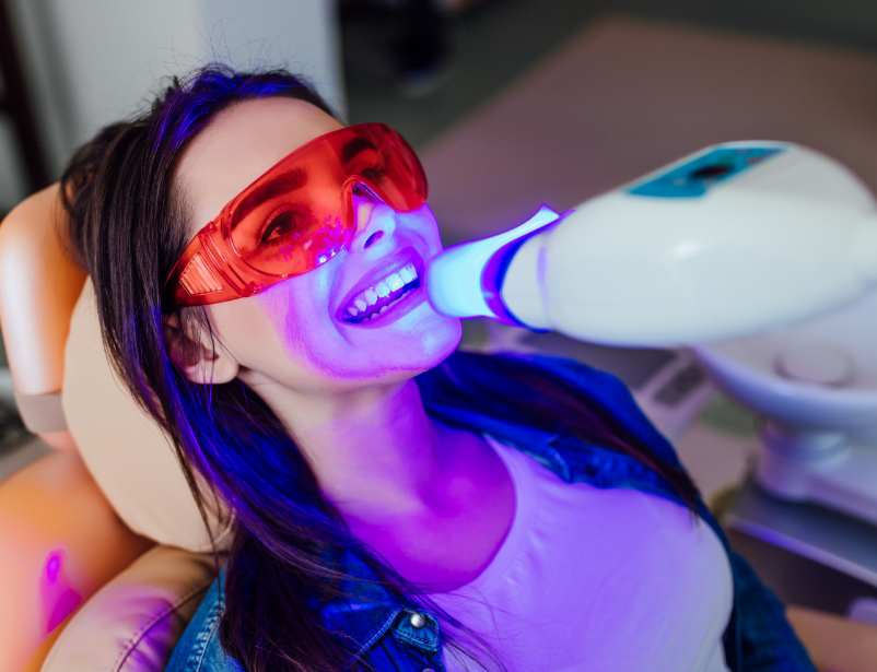 Woman getting professional whitening treatment
